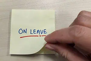 Reminder note marked 'ON LEAVE,' symbolizing absence or break from work